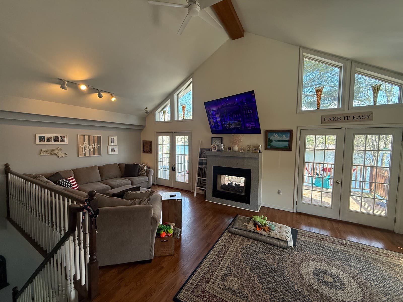 The great room, fireplace, and pond-facing windows